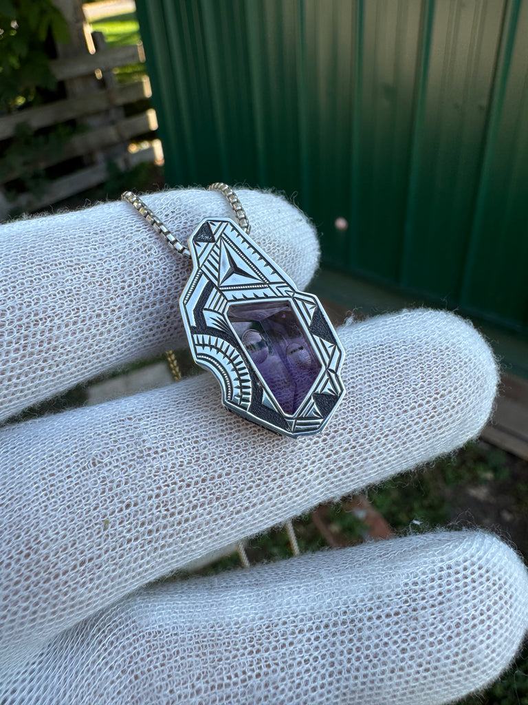 Amethyst, sapphire, and garnet pendant